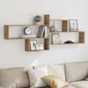 A wooden wall shelf unit mounted on a white wall above a sofa. Voir les images du produit