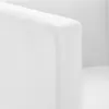 A close-up view of the corner of a white cube-shaped armchair, showing the stitching detail. Anteprima dell’immagine prodotto