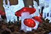 Illuminated LED mushrooms and reindeer figures are displayed on a bed of mulch, likely as outdoor holiday or garden decorations. Produktbild-Vorschau