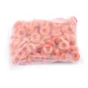 A clear, well-lit studio shot of a bag of orange ring-shaped objects, likely animal castration bands, against a plain white background. Produktbild-Vorschau