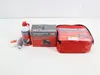 A car tire repair kit with a compressor and sealant is laid out on a white surface. Produktbild-Vorschau