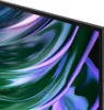 A close-up view of a television screen displaying an abstract, swirling pattern of green and purple colors. Produktbild-Vorschau