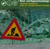 A construction site with a green safety net and a warning sign. Produktbild-Vorschau