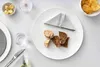 A table setting with a plate of bread, a napkin, a glass of water, and a bowl of chips. Podgląd zdjęcia produktu