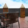An outdoor patio with chairs and a table, with a privacy screen in the background. Produktbild-Vorschau