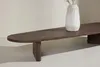 A wooden coffee table with a vase on top, against a neutral background. Produktbild-Vorschau