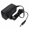 A black power adapter with a coiled cord and a connector. Produktbild-Vorschau
