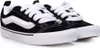A pair of black Vans sneakers with white laces and a white side stripe, shown from a slightly elevated side angle against a white background. Voir les images du produit