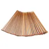 A collection of wooden knitting needles fanned out on a white background. Podgląd zdjęcia produktu