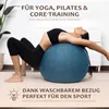 A woman is using a blue exercise ball for a yoga pose. Produktbild-Vorschau
