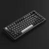 A black mechanical keyboard is shown from a slightly elevated, diagonal angle against a black background. Produktbild-Vorschau