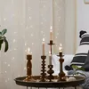 Candles on a tray in front of a curtain with fairy lights. Produktbild-Vorschau
