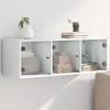 A white wall-mounted cabinet with glass doors, displaying decorative items and boxes. Voir les images du produit