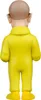 The back view of a small figurine of a bald man wearing a yellow jumpsuit. Podgląd zdjęcia produktu