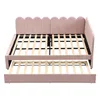 A pink upholstered daybed with a pull-out trundle bed is shown from the front. Náhľad obrázku produktu