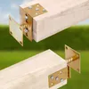 Two wooden beams are shown with metal brackets attached, set against a blurred green and blue background. Anteprima dell’immagine prodotto