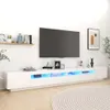 A white TV stand with LED lighting is shown in a room with a TV mounted on the wall above it. Náhled obrázku produktu