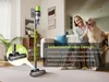 A woman and her dog are relaxing on a couch, with a vacuum cleaner standing freely in the foreground. Produktbild-Vorschau