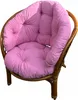 A pink cushion set on a rattan chair. Produktbild-Vorschau