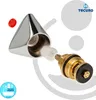 A disassembled faucet part with a chrome handle and brass valve. Produktbild-Vorschau