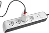 A white and black power strip with a white charging adapter plugged into one of the sockets. Náhľad obrázku produktu