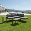 An outdoor living space with a modern house, swimming pool, and mountains in the background, featuring a gray sectional sofa and coffee tables on a green lawn. Náhled obrázku produktu