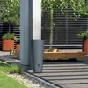 A modern outdoor patio setting with a rain barrel, plants, and wooden bench. Produktbild-Vorschau