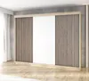 A modern wardrobe with sliding doors and slatted panels, set against a concrete wall and wooden floor.