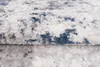A close-up, textured view of a rug with a distressed pattern of blue and gray on a white background. Náhled obrázku produktu