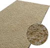 A close-up view of a beige shaggy rug with a magnified inset showing the texture of the fibers. Náhled obrázku produktu