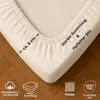 A close-up of a fitted sheet corner, showing the elasticized edge and fabric texture, with informational icons and text at the bottom. Produktbild-Vorschau