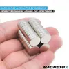 A hand holding several small, cylindrical magnets. Podgląd zdjęcia produktu
