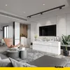 A modern living room with a white sideboard, TV, and a stylish armchair. Voir les images du produit