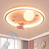 A close-up view of a pink cartoon-themed LED ceiling light for a child's room, featuring a figure of a girl flying amongst planets and stars. Produktbild-Vorschau