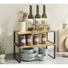 A two-tier kitchen shelf unit with various kitchen items displayed on it. Anteprima dell’immagine prodotto