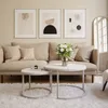 A living room scene with a sofa, coffee tables, and wall art. Náhľad obrázku produktu