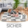 A mother and child playing on a foam mat in a living room. Náhled obrázku produktu