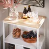 A kitchen cart with various items on its shelves, including drinks, glasses, fruit, and dried fruit. Náhled obrázku produktu