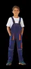 A young boy wearing blue and orange overalls and a white t-shirt, standing against a black background. Produktbild-Vorschau