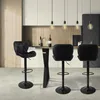Three black bar stools are arranged in a modern kitchen setting. Produktbild-Vorschau