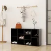 An entryway scene featuring a black shoe cabinet with shoes, a coat rack with clothing and accessories, and a handbag on top of the cabinet. Náhled obrázku produktu