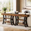 A long, rustic console table with shelves is placed behind a sofa in a well-lit living room, with a large window in the background. Anteprima dell’immagine prodotto