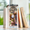 A miniature book nook designed to look like an arcade dating scene, placed between two books. Podgląd zdjęcia produktu