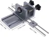 A close-up, angled view of a metal drilling jig with measurement markings. Náhled obrázku produktu