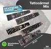 A person wearing a black jacket, with several tattoo sleeves laid out in front of them. Voir les images du produit