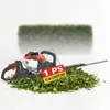 A hedge trimmer is shown lying on a pile of cut leaves, with a sign indicating its specifications. Produktbild-Vorschau
