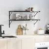 A kitchen scene with two black wall shelves mounted on a tiled wall above a countertop. Anteprima dell’immagine prodotto