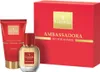 A gift set containing a perfume bottle and a shower gel tube, presented next to a red gift box. Voir les images du produit