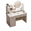 A white vanity table with a round mirror and various makeup products displayed on it. Náhľad obrázku produktu