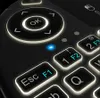 A close-up view of a black wireless keyboard with illuminated keys and navigation buttons. Anteprima dell’immagine prodotto